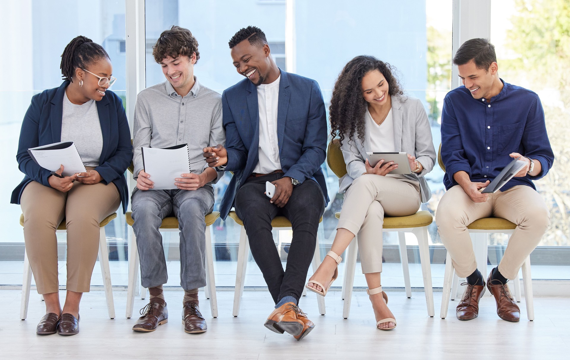 Shot of a group of businesspeople sitting in line in an office