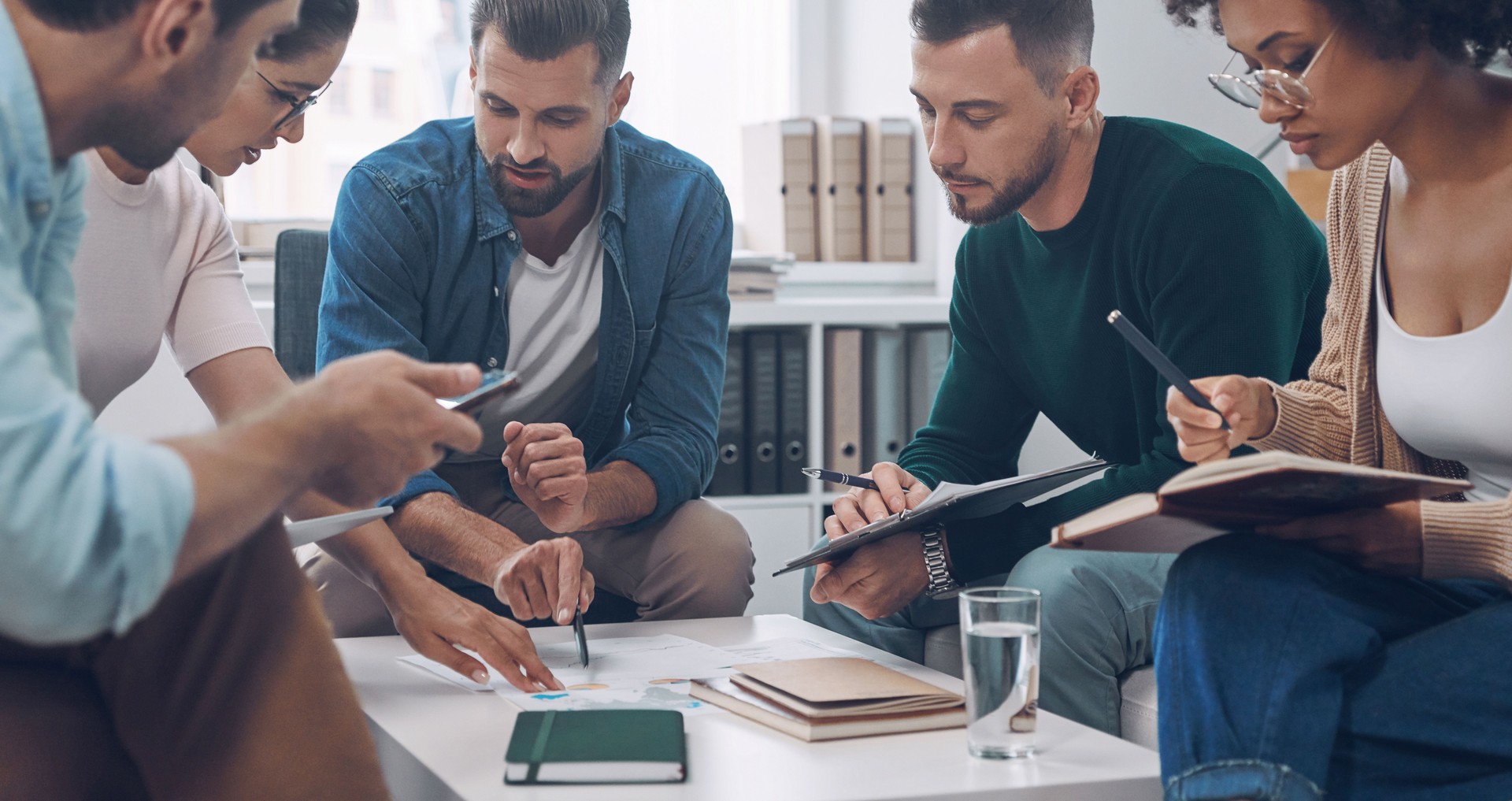 Group of modern young people discussing business